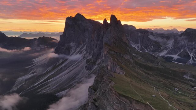 Cinematic aerial video of spectacular sunrise at the Seceda mountain ridge line in the Italian Dolomites