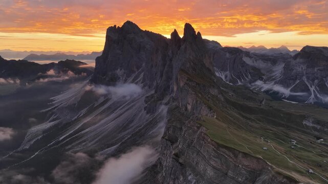 Cinematic aerial video of spectacular sunrise at the Seceda mountain ridge line in the Italian Dolomites