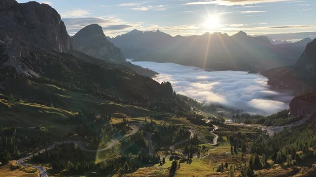 Cinematic aerial video of Gardena Pass in the Italian Dolomites during morning golden hour