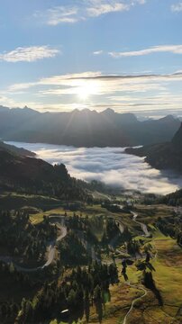 Cinematic aerial video of Gardena Pass in the Italian Dolomites during morning golden hour