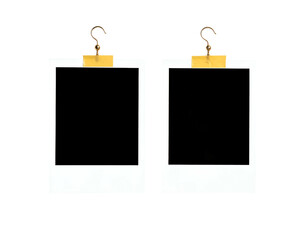 Two empty photo frames hang by hooks