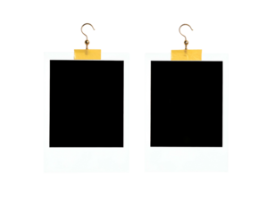 Two empty photo frames hang by hooks