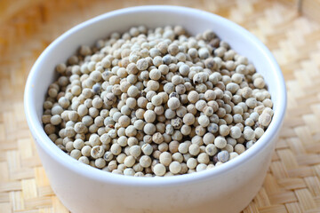 White peppercorns, used to add sharp, lasting heat and aroma to dishes.