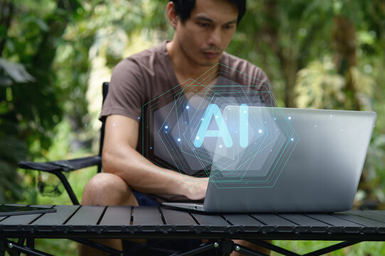 Man Using Laptop Outdoors with Artificial Intelligence Concept