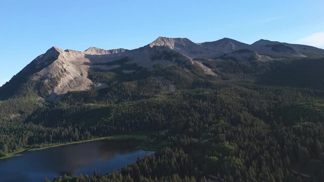 Drone flight at sunset over an alpine lake near Kebler Pass, in Crested Butte, Colorado