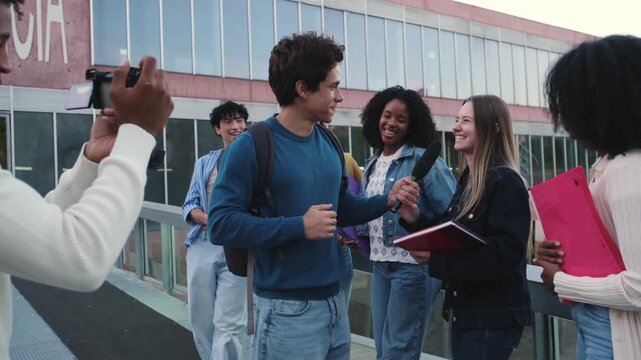 Group of diverse student journalists interviewing a young woman outside a university building