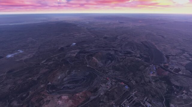 Top aerial drone view at sunset of the Bayan Obo Mining District in Baotou. Inner Mongolia. China