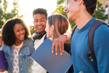 Group of happy young students walking and smiling during an outdoor break