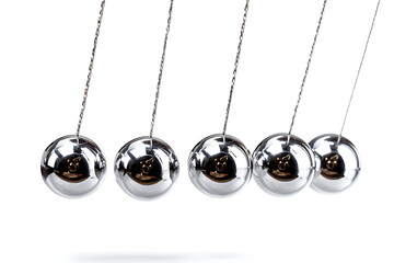 Elegant metallic spheres in motion, a symbol of balance and kinetic energy, perfect for illustrating physics concepts, stress management, or creating a visually striking design element