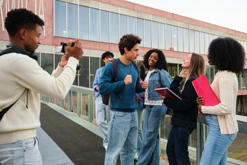 Group of young diverse students filming an interview for social media at university