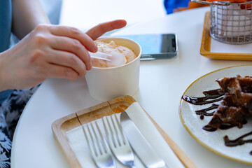 Person Eating Dessert at Restaurant Table