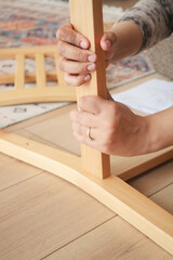 Setting up a wooden furniture piece on a warm floor