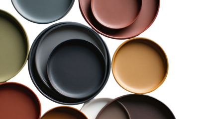 Colorful, modern plates layered on top of each other, dark background