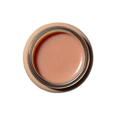 Top-down view of tan liquid in clear round jar, on brown surface