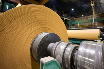 Production of kraft paper in a large manufacturing plant during daytime operations