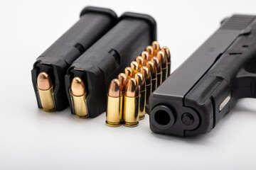 Gun magazines and bullets ammunition with pistol gun on white background , Gun law