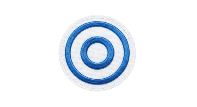 Embroidered circular patch with blue concentric rings on white fabric, isolated studio shot