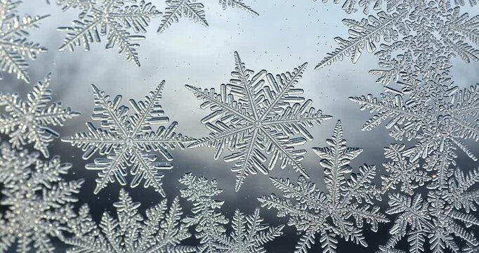 Intricate frost patterns on a windowpane, showcasing nature's artistry in winter scenery