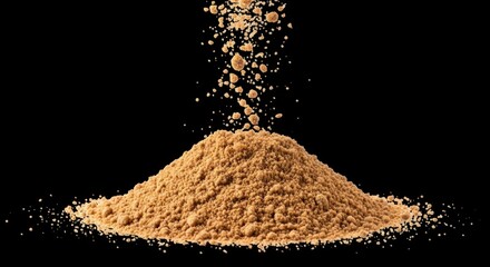 Pile of brown powder on black background
