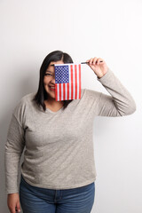 40-year-old Latina woman proudly displays the United States flag as a symbol of migration and freedom