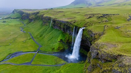 Majestic Seljalandsfoss waterfall cascading down rocky cliffs in the lush landscapes of Iceland