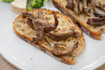 Beef steak pieces on a toast.