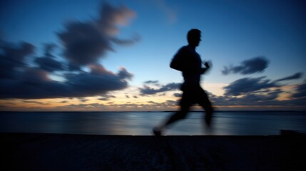 Silhouette of running man, dynamic figure at twilight by the water, with colorful sky and blurred clouds, close-up, copy space