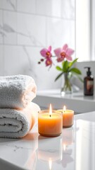 Serene bathroom scene with glowing candles, fluffy towels, and a vase of pink orchids. Soft lighting and sleek marble create a spa-like atmosphere