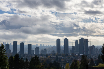 Fototapeta premium City Skyline With High Rise Buildings Under Dramatic Clouds Over Burnaby, Greater Vancouver, Canada