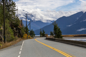 Winding Mountain Road Along Waterfront With Trees and Clouds in Pemberton, BC, Canada
