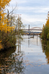 Fototapeta premium Autumn River Scene With Bridge Construction in New Westminster, Greater Vancouver