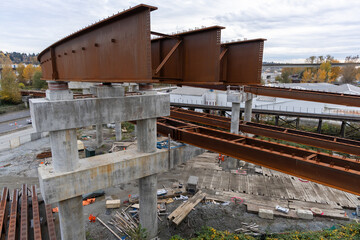 Industrial Construction Site With Rusty Steel Beams On Concrete Pillars – Overhead View Of...