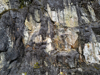 Rugged Granite Cliff Face With Textured Rock Formations and Moss in BC, Canada