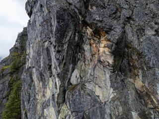 Steep Rocky Cliff Face With Moss and Pine Forest In Mountain Terrain, BC Canada