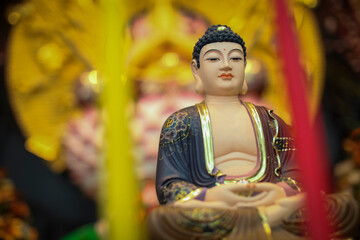 Serene Buddha Statue Amid Colorful Shrine Decor For Meditation, Peace, And Spirituality