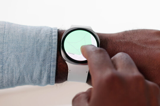 Young African American Man Uses Smart Watch For Fitness Instructions