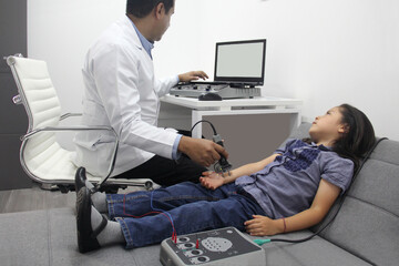 Electromyography EMG and Nerve Conduction Velocity NCV of the hand and arm in a 6-year-old Latina girl with a doctor