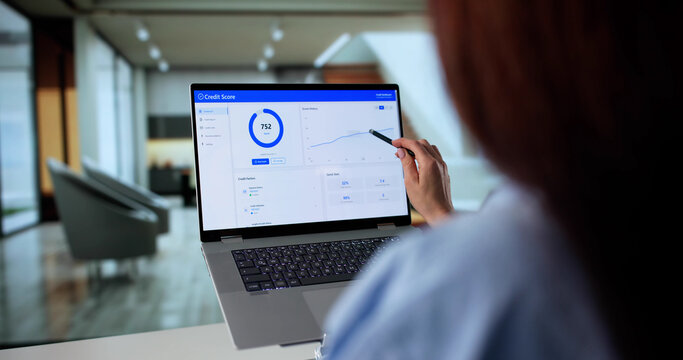 Young Businesswoman Browsing Online For Credit Score Ratings