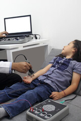 Electromyography EMG and Nerve Conduction Velocity NCV of the hand and arm in a 6-year-old Latina girl with a doctor
