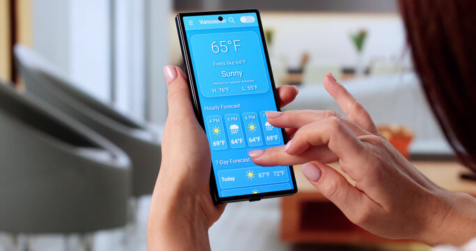 Young Woman Consulting Weather Forecast App On Smartphone