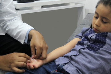 Electromyography EMG and Nerve Conduction Velocity NCV of the hand and arm in a 6-year-old Latina girl with a doctor