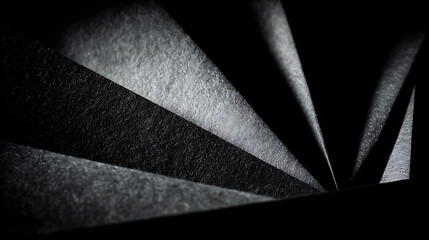 Abstract dark paper folds with textured light background black