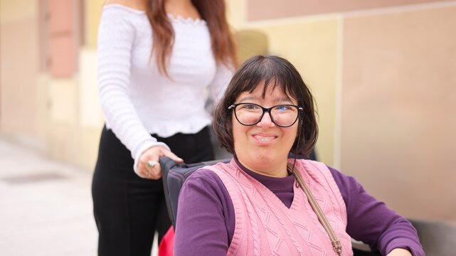 Happy woman with physical disability smiling, receiving assistance