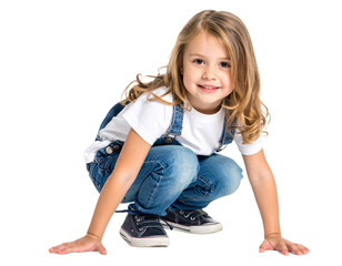 Happy little girl crouching down isolated on white background, transparent PNG