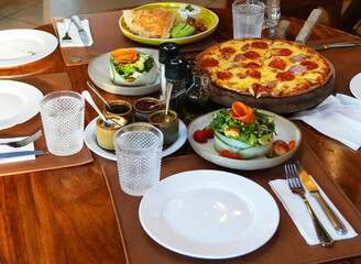 dinner table with fresh made pizza and salad