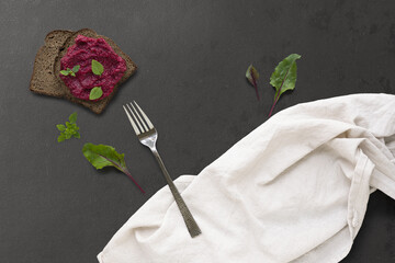 Natural lighting highlights rustic bread and greens, Home chef captures moody scene of beet spread toast
