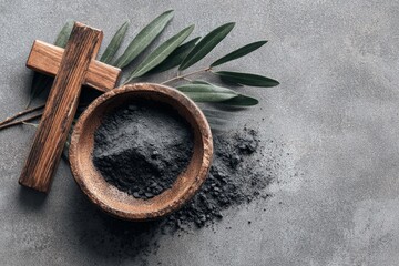 Religion, faith, liturgy, Ash Wednesday, Lent background. Brown wooden cross, ceremonial ash bowl and olive branch on grunge gray background