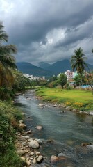 Fototapeta premium Serene river scene under stormy sky, mountains, trees, and a town visible