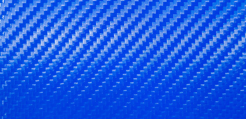 Horizontal background made of blue carbon fiber.Blue sports carbon background.