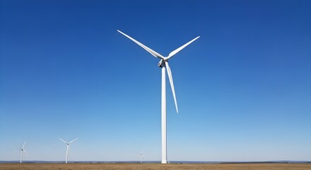Minimal wind turbine standing against clear blue sky representing clean renewable energy